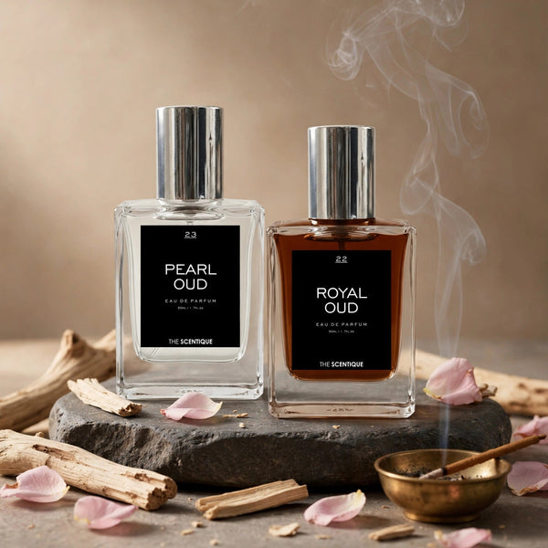 Soft Oud Deal — two oud bottles on dark stone with sandalwood, rose petals, incense bowl